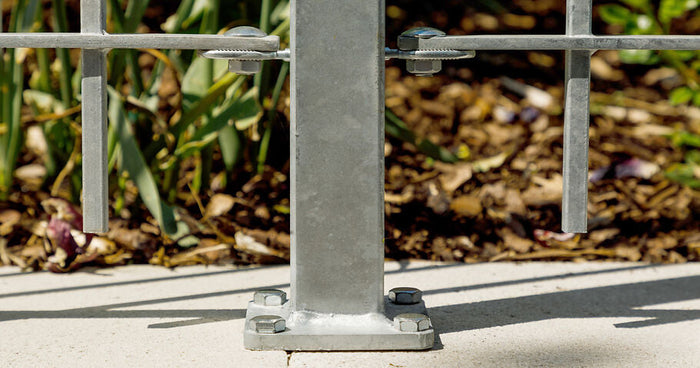 Is it better to concrete in fence posts or screw-mount them? A comparison.